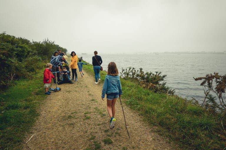 Locmiquélic, famille se promenant sur un sentier le long du littoral au milieu de la réserve de Pen Mané